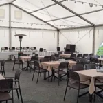 Namiot eventowy Hotelu 500 Zegrze przygotowany na szkolenie lub spotkanie firmowe, ze stołami, bufetem i miejscami dla uczestników.